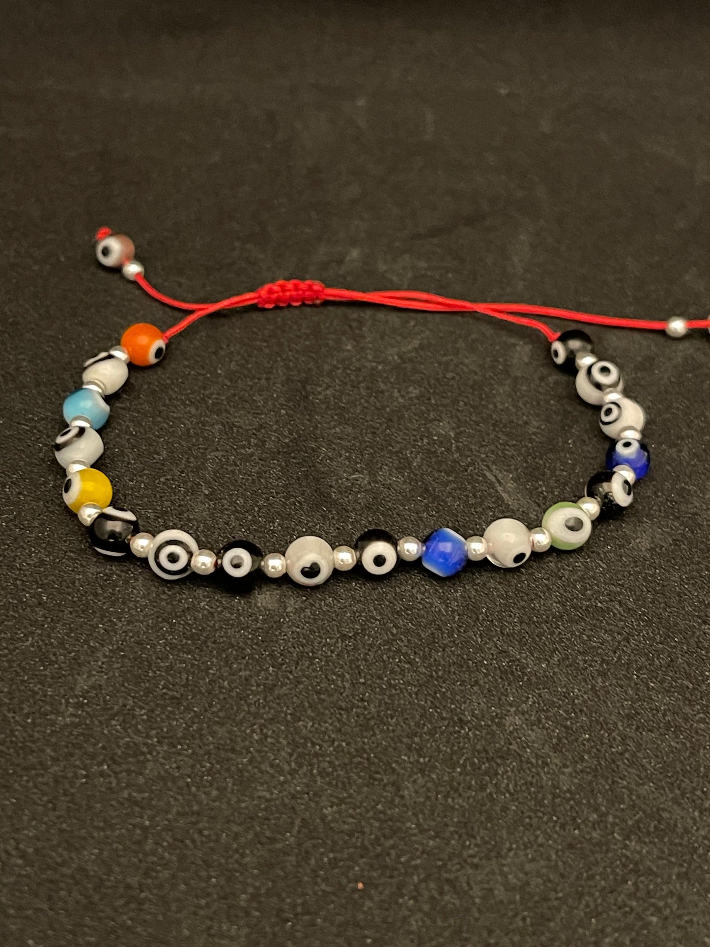 PULSERITA con plata de Ojitos de colores