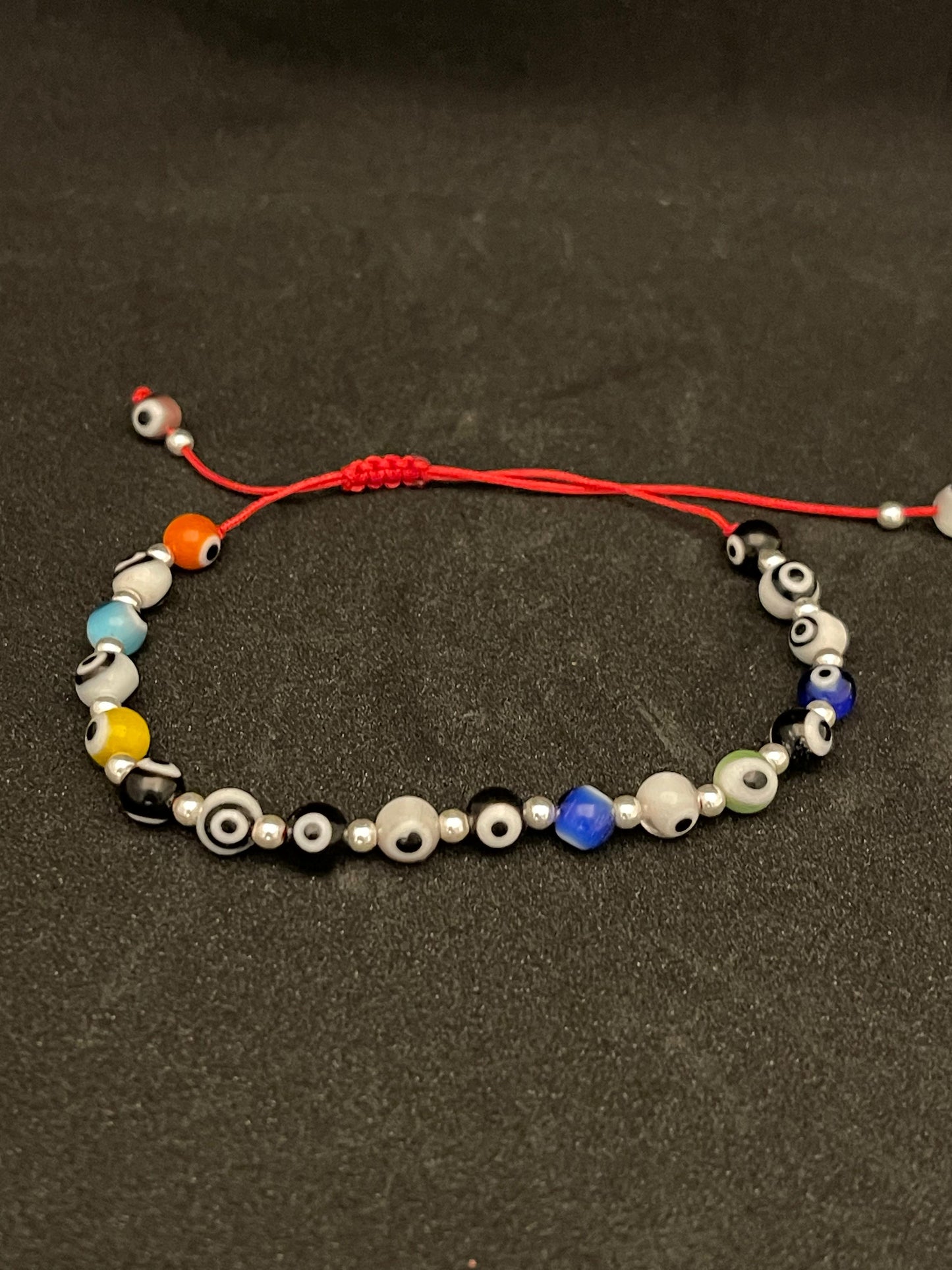 PULSERITA con plata de Ojitos de colores